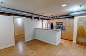 This 640 square foot apartment in Richmond, VA, seamlessly melds modern convenience with industrial character. The open-concept layout maximizes the use of space, featuring a well-appointed kitchen as its centerpiece. The kitchen boasts granite countertops, stainless steel appliances, and light wood cabinetry, creating a sleek and functional cooking area. Exposed ductwork and original wooden beams add architectural interest and height to the space, while track lighting provides adjustable illumination.

The two bedrooms offer ample space, with the primary bedroom measuring a generous 180 square feet. Hardwood floors run throughout, lending warmth and continuity to the living areas. Large windows in the bedrooms allow for natural light, enhancing the sense of space.

The bathroom, while compact, is efficiently designed with modern fixtures, including a pedestal sink and a shower/tub combination. Built-in storage helps maximize the available space.

One of the apartment's most striking features is the exposed brick wall, which adds texture and a touch of historical charm to the otherwise contemporary space. This unique blend of old and new creates a distinctive urban living environment, perfect for those seeking a stylish city dwelling with character.
