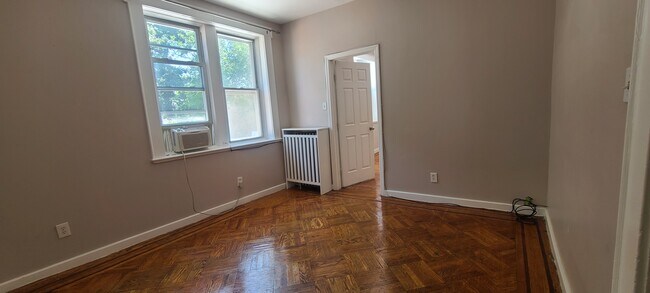 Livingroom w large windows, beautiful wood floor &custom radiator cover - 31 Park Ave