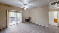 Located at 3601 S Lake Mary Rd in Flagstaff, Arizona, this single-floor, 2-bedroom, 2-bathroom residence offers a well-organized and functional layout. The kitchen is equipped with warm wood cabinetry, dark laminate countertops, a double sink, white appliances including a range and built-in microwave, and tile flooring. Track lighting and a peninsula counter provide both practicality and an open connection to the adjacent living area. The spacious living room features plush carpeting, a ceiling fan, a tiled corner fireplace, and a sliding glass door that invites natural light and outdoor access. Both bedrooms are carpeted and include ceiling fans and walk-in closets outfitted with built-in shelving and hanging rods, offering generous storage. The two bathrooms are finished with tile flooring, warm-toned walls, wood vanity cabinetry, and full tub-shower combinations with chrome fixtures. A dedicated laundry area adds everyday convenience. Throughout the residence, neutral beige tones and white trim create a clean, cohesive aesthetic. The overall layout is efficient and comfortable, making this Flagstaff property a practical and inviting place to call home.