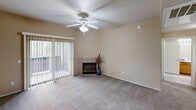 Located at 3601 S Lake Mary Rd in Flagstaff, Arizona, this single-floor, 2-bedroom, 2-bathroom residence offers a well-organized and functional layout. The kitchen is equipped with warm wood cabinetry, dark laminate countertops, a double sink, white appliances including a range and built-in microwave, and tile flooring. Track lighting and a peninsula counter provide both practicality and an open connection to the adjacent living area. The spacious living room features plush carpeting, a ceiling fan, a tiled corner fireplace, and a sliding glass door that invites natural light and outdoor access. Both bedrooms are carpeted and include ceiling fans and walk-in closets outfitted with built-in shelving and hanging rods, offering generous storage. The two bathrooms are finished with tile flooring, warm-toned walls, wood vanity cabinetry, and full tub-shower combinations with chrome fixtures. A dedicated laundry area adds everyday convenience. Throughout the residence, neutral beige tones and white trim create a clean, cohesive aesthetic. The overall layout is efficient and comfortable, making this Flagstaff property a practical and inviting place to call home.