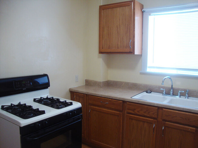 Gas stove, sink and cupboard space. - 239 W Venango St