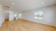 Located at 226 North Hoke Street in Stillwater, Oklahoma, this contemporary two-story home offers four bedrooms, five bathrooms, and a thoughtfully designed layout spread across two floors. The main level provides generous living and kitchen space, while the upper floor houses additional bedrooms and baths.

The open-concept kitchen is a standout feature, showcasing crisp white shaker cabinetry with matte black hardware, a subway tile backsplash, stainless steel appliances including a gas range and French door refrigerator, and a large center island with a quartz countertop and undermount sink. The kitchen flows seamlessly into the living area, which benefits from abundant natural light through multiple windows.

Light-toned hardwood-style flooring runs consistently throughout the home, complementing the clean white walls and recessed lighting to create a bright, cohesive aesthetic. Bedrooms are well-proportioned, each featuring ceiling fans and windows that invite natural light. Closet space is conveniently integrated into the bedrooms. The bathrooms are finished in a modern style, featuring black-framed glass shower enclosures and matching matte black fixtures that echo the home's consistent design language.

Outside, a fully fenced backyard with mature shade trees provides a private outdoor retreat. The combination of clean finishes, functional layout, and modern details makes this home an attractive and practical residence.
