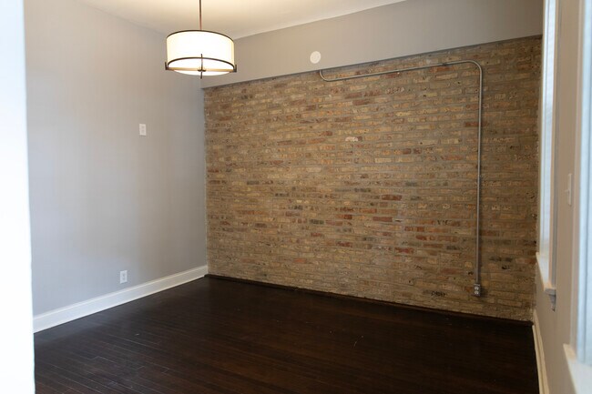living/family room with exposed brick - 2246 W Charleston St