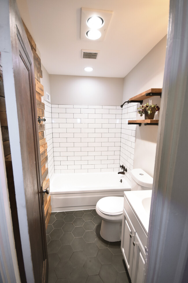 bespoke pallet wall in freshly tiled bathroom - 10105 Burton Ave