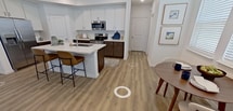 This 1,320-square-foot, two-story residence at 9002 S Collins St, Arlington, TX, is thoughtfully designed across two floors totaling 520 sq ft on the ground level and 800 sq ft above. The home features two bedrooms, three bathrooms, a dedicated office, and two closets throughout its well-organized layout.

The ground floor centers on an open-concept kitchen and living area. The kitchen showcases white upper cabinetry paired with dark lower cabinets, stainless steel appliances including a refrigerator, microwave, and range, and a white quartz island with bar seating. Light wood-tone flooring flows seamlessly into the living room, which features large windows allowing generous natural light. A dedicated office on this floor includes a ceiling fan, window, and hardwood-style flooring.

Upstairs, the 210-square-foot primary bedroom offers a ceiling fan, wood-style flooring, and access to a walk-in closet with built-in shelving and hanging rods. The secondary bedroom mirrors this design with its own ceiling fan. Three bathrooms serve the home, including one with a full soaking tub and shower combination. Clean white walls, recessed lighting, and consistent flooring throughout contribute to a cohesive, modern aesthetic.