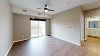 Located at 2635 N Forest Rd in Getzville, NY, this one-bedroom, one-bathroom unit offers a thoughtfully designed single-floor layout with modern finishes throughout. The open-concept kitchen and living area forms the heart of the space, where light wood-tone flooring, neutral taupe walls, and recessed lighting create a clean, contemporary atmosphere. The kitchen features white shaker-style cabinetry, granite countertops, stainless steel appliances including a refrigerator, range, and microwave, and a peninsula with pendant lighting and an undermount sink — ideal for both everyday use and entertaining. The living area extends naturally from the kitchen and includes a ceiling fan with light fixture and sliding glass doors that open to a private balcony, bringing in natural light and outdoor views. The bedroom is carpeted for comfort, features a window with outdoor views, and is conveniently positioned near the kitchen. The bathroom is well-appointed with white shaker vanity cabinetry, granite countertops, a large mirror, and wood-tone flooring. A dedicated utility room provides additional practicality. The unit presents a cohesive, move-in-ready aesthetic throughout.