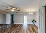Located at 3901 36th Ct in West Palm Beach, Florida, this single-story home offers a well-designed layout with consistent finishes throughout. The open living and dining area is anchored by rich wood-look flooring, neutral gray walls, and textured ceilings. Ceiling fans provide comfort in the main living spaces, while an elegant chandelier adds a refined touch to the dining area. Natural light flows in through windows dressed with horizontal blinds, and a front-facing window offers views of the surrounding neighborhood.

The kitchen is thoughtfully appointed with white shaker-style cabinetry featuring sleek bar-pull hardware, a light subway tile backsplash, ample counter space, a stainless steel sink, and black appliances including an electric range.

The bedrooms continue the wood-look flooring and neutral palette, each offering natural light and closet storage with louvered bifold doors. One bedroom includes a ceiling fan, while another features direct access to a bathroom.

The home includes two full bathrooms. One showcases a jetted soaking tub with white tile surround, while the second offers a tub-shower combination with white tile and a vanity with stone-look countertops. Together, these spaces present a clean, move-in ready home in a convenient West Palm Beach location.