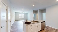 Located at 2331 Cadotte Dr SW in Wyoming, Michigan, this single-floor, 3-bedroom, 2-bathroom home offers a clean, modern aesthetic throughout. The open-concept layout seamlessly connects the kitchen, dining, and living areas, creating a bright and cohesive common space. The kitchen is a standout feature, equipped with white shaker cabinetry, granite countertops, stainless steel appliances including a refrigerator, range, and microwave, and a central island with a undermount sink — ideal for both cooking and casual dining. Recessed lighting and light-toned luxury vinyl plank flooring extend across the main living areas, enhancing the sense of openness and warmth. The living room benefits from natural light through a window overlooking the exterior, and is fitted with a ceiling fan. The bedrooms are carpeted for comfort, with the primary bedroom offering a spacious closet with built-in shelving. The bathrooms feature granite-topped vanities with white cabinetry and wood-look flooring, with one bath including a full tub-shower combination. A dedicated laundry room houses a full-size washer and dryer alongside the water heater and HVAC system. Four closets throughout provide ample storage for everyday living.