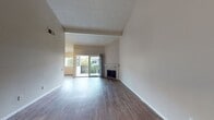 This contemporary 890 square foot apartment in Costa Mesa offers a well-designed living space with two bedrooms and two bathrooms. The open-concept layout seamlessly integrates the living room, dining area, and kitchen, creating a spacious feel. The living room features laminate wood flooring and a cozy fireplace, complemented by large sliding glass doors that lead to a private balcony, allowing natural light to flood the space.

The updated kitchen boasts modern cabinetry, stainless steel appliances, and ample counter space, perfect for culinary enthusiasts. Both bedrooms are generously sized, with the primary bedroom measuring 160 square feet. They feature plush carpeting and large windows for a bright, airy ambiance. The bathrooms are tastefully appointed with modern fixtures, including a combination tub-shower in one and a stand-alone shower in the other.

Throughout the apartment, neutral tones create a calming atmosphere, while the textured ceilings add character. The unit's single-floor layout ensures easy accessibility, making it an ideal choice for various lifestyles. Located in the desirable Costa Mesa area, this apartment combines modern comfort with urban convenience.