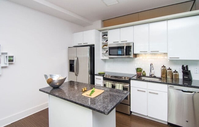 Kitchen with granite countertops and stainless steel appliances - The Lex at Waterfront