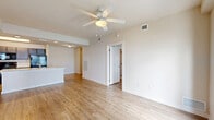 Located at 10 Betty Rose Drive in Key West, Florida, this well-appointed one-bedroom, one-bathroom residence offers a comfortable and functional layout across a single floor. Light wood-tone flooring runs throughout the entire space, creating a cohesive and airy aesthetic that complements the neutral, warm-white walls found in every room.

The open-concept living, dining, and kitchen area serves as the heart of the home. The living room is generously sized, featuring a ceiling fan with light fixture and direct access to a private balcony through a glass door flanked by windows that invite natural light. The kitchen is thoughtfully equipped with dark espresso cabinetry, light stone-finish countertops, a peninsula island with a sink, and a full suite of black appliances including a refrigerator, range, and microwave. A wide hallway connects the main living area to the private quarters, lined with multiple closet spaces providing ample storage.

The bedroom is a calm retreat with a ceiling fan, a window with an outdoor view, and generous proportions. The bathroom features wood-toned cabinetry, a single vanity with a marble-look countertop, and light wood flooring consistent with the rest of the home. A dedicated laundry area adds everyday convenience to this well-designed Key West residence.