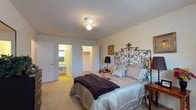 Located at 2414 Stone Rd in East Point, GA, this two-story home offers a thoughtfully organized layout spread across two floors connected by a carpeted staircase. The main level features a welcoming living room with plush carpeting, a large sliding glass door that opens to an outdoor view, and ample natural light that creates an inviting atmosphere. Adjacent to the living area is a dedicated dining space with hardwood-style flooring, ideal for everyday meals. The galley-style kitchen is efficiently designed with white cabinetry, generous counter space, a gas range, dishwasher, and refrigerator — all arranged for practical use. A louvered door off the kitchen conceals additional storage or utility space. A bathroom on the main level features a wide vanity with an extended countertop and well-lit mirror. Upstairs, the carpeted bedrooms offer a comfortable retreat, with the primary bedroom notable for its ceiling fan, walk-in closet, and direct access to a private bathroom. Additional bedrooms provide natural light through well-placed windows. Throughout the home, neutral tones and textured ceilings lend a clean, classic aesthetic, while the multi-level layout provides a clear separation between living and sleeping spaces.