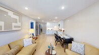 Located at 1090 Main St in South Windsor, CT, this thoughtfully designed single-floor residence offers a comfortable and contemporary living experience across two bedrooms, one bathroom, and a dedicated office space. The open-concept living, dining, and kitchen area forms the heart of the home, bathed in natural light from well-placed windows and recessed lighting overhead. Light-toned hardwood flooring flows seamlessly throughout, lending a sense of warmth and cohesion to every room. The kitchen is outfitted with crisp white cabinetry extending to the ceiling, stainless steel appliances including a range, dishwasher, and over-the-range microwave, and a clean white countertop — all combining for a sleek, functional workspace. A compact dining area sits adjacent, ideal for everyday meals. The living room features a bold navy blue entry door that serves as a striking design accent, repeated across interior doors throughout the residence. The primary bedroom is generously sized and includes a double-door closet and a wall-mounted mini-split system. The office provides a quiet, dedicated workspace. The bathroom is elegantly finished with large-format tile walls, a wood-toned vanity, and a walk-in shower.