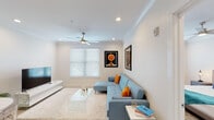 This 1-bedroom, 1-bathroom residence is thoughtfully designed with a clean, modern aesthetic and an efficient single-floor layout. The open-concept living and dining area features light hardwood-style flooring, crown molding, recessed lighting, and a ceiling fan, creating a bright and airy atmosphere. A large window with blinds allows natural light to fill the space, complementing the neutral color palette. The kitchen is a standout feature, offering light wood flat-front cabinetry, white quartz countertops, stainless steel appliances including a refrigerator, electric range, built-in microwave, and dishwasher, along with a double-basin sink and stylish pendant lighting. The bedroom is generously proportioned, with recessed lighting, a ceiling fan, a large window, and ample room for a king-size bed and additional seating. The full bathroom is finished with light wood-look tile flooring, a tiled tub-shower combination with subway-style wall tiles, a quartz-topped vanity with modern cabinetry, and gold-toned hardware accents. Throughout the residence, consistent finishes and a cohesive color scheme tie the spaces together, offering a polished and comfortable living environment.