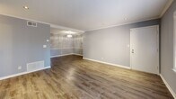 Located in the desirable Buckhead neighborhood of Atlanta, this 2-bedroom, 2-bathroom single-story home offers a well-designed layout with modern finishes throughout. The open living room features rich hardwood-style flooring, crown molding, recessed lighting, and soft gray walls that create a clean, contemporary atmosphere. Adjacent, the dining room flows naturally from the living space, maintaining the same refined aesthetic.

The kitchen is a standout feature, equipped with white shaker-style cabinetry, granite countertops, a subway tile backsplash, stainless steel appliances including a dishwasher, and a deep double-basin sink. Multiple windows flood the space with natural light, and a louvered door provides convenient access to the laundry area.

The primary bedroom is generously sized, offering hardwood-style floors, a ceiling fan, a natural light-filled window with outdoor views, and dedicated closet space. The second bedroom mirrors this comfortable scale with similar finishes and its own ceiling fan. Both bathrooms are well-appointed — one featuring warm wood cabinetry with a white countertop vanity and a window, the other with classic white subway tile surrounding a tub-shower combination. Multiple closets and utility rooms provide ample storage throughout.