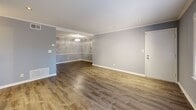 Located in the desirable Buckhead neighborhood of Atlanta, this 2-bedroom, 2-bathroom single-story home offers a well-designed layout with modern finishes throughout. The open living room features rich hardwood-style flooring, crown molding, recessed lighting, and soft gray walls that create a clean, contemporary atmosphere. Adjacent, the dining room flows naturally from the living space, maintaining the same refined aesthetic.

The kitchen is a standout feature, equipped with white shaker-style cabinetry, granite countertops, a subway tile backsplash, stainless steel appliances including a dishwasher, and a deep double-basin sink. Multiple windows flood the space with natural light, and a louvered door provides convenient access to the laundry area.

The primary bedroom is generously sized, offering hardwood-style floors, a ceiling fan, a natural light-filled window with outdoor views, and dedicated closet space. The second bedroom mirrors this comfortable scale with similar finishes and its own ceiling fan. Both bathrooms are well-appointed — one featuring warm wood cabinetry with a white countertop vanity and a window, the other with classic white subway tile surrounding a tub-shower combination. Multiple closets and utility rooms provide ample storage throughout.