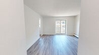 This well-appointed 2-bedroom, 1-bathroom unit at 49 McMurchy Ave N in Brampton offers a clean, modern aesthetic throughout its efficiently designed single-floor layout. The open living area is finished with light-toned vinyl plank flooring and crisp white walls, creating a bright and airy atmosphere. Sliding glass doors lead to a private balcony, allowing natural light to flood the space and providing outdoor access. The kitchen is thoughtfully updated, featuring white shaker-style cabinetry, dark countertops, a classic white subway tile backsplash, a stainless steel double sink, and stainless steel appliances including a dishwasher and electric range. Both bedrooms continue the consistent flooring and neutral palette, with the primary bedroom offering a comfortable footprint. Baseboard heating units are present in the bedrooms, ensuring year-round comfort. The bathroom is finished with floor-to-ceiling white subway tile surrounding a soaker tub with an overhead shower. A dedicated entrance and hallway provide a practical transition into the living areas. Throughout the unit, clean lines, white trim, and modern door hardware contribute to a cohesive, contemporary feel.