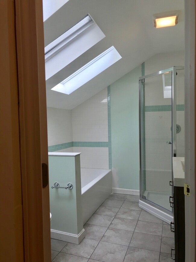 New bathroom with Bathtub and Shower. Three skylights lets the sunlight in. - 51 Pleasant St