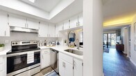Located at 2554 Oak Trail S in Clearwater, Florida, this thoughtfully designed single-floor residence offers a cohesive blend of modern finishes and comfortable living spaces. The kitchen is a standout feature, showcasing crisp white cabinetry with brushed nickel hardware, stainless steel appliances including a range and dishwasher, white quartz countertops, a double-basin sink, and a striking skylight that floods the space with natural light. Wood-look flooring flows throughout, creating a warm and unified aesthetic.

The open-concept living and dining area is bright and inviting, with a softly painted accent wall in muted blue tones and large sliding glass doors that open to a private outdoor patio — offering pleasant views of the surrounding greenery. The seamless indoor-outdoor connection makes this space ideal for relaxed everyday living.

The bedroom is a restful retreat, featuring a bold navy accent wall, large windows with ample natural light, and generous dual closet storage with sliding doors. The bathroom is cleanly appointed with a full tub-shower combination, white vanity, and coordinating navy accents. Built-in shelving in the living area adds both style and functional storage throughout this well-appointed Clearwater home.
