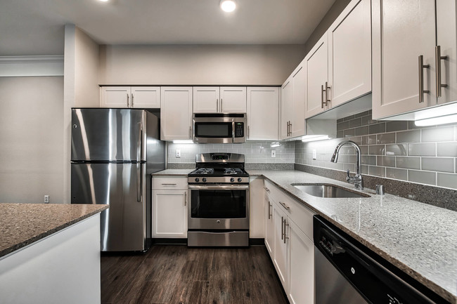 Renovated kitchens with quartz counters and stainless steel appliances - The Estates at Cougar Mountain