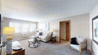 Located at 615 Robinwood Ln in Hopkins, Minnesota, this single-floor residence offers a comfortable and thoughtfully arranged living space. The living room serves as the heart of the home, featuring neutral-toned carpet, soft wall colors, and large windows with vertical blinds that allow natural light to fill the room. The open layout accommodates both a relaxed seating area and a defined entryway with a console table and mirror, creating a welcoming first impression.

The kitchen is equipped with a smooth-top electric range, a decorative pressed-tin backsplash that adds a distinctive design touch, under-cabinet ventilation, and a full-size refrigerator. Cabinetry provides ample storage, and the countertops offer functional workspace.

The bedroom is a calm retreat, finished with plush carpet, warm neutral walls, and a ceiling fan with a light fixture. A window with blinds allows for natural light while maintaining privacy, and baseboard heating ensures year-round comfort.

The bathroom features a tiled countertop and backsplash surrounding a clean white sink basin, complemented by a large mirrored medicine cabinet and warm wood-toned cabinetry. Natural light from an adjacent space creates a bright, airy atmosphere in this well-appointed room.