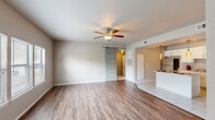 This single-story Oklahoma City residence offers a thoughtfully designed layout with 2 bedrooms, 4 bathrooms, 2 closets, and a hallway connecting all living spaces. The open living room is a standout, showcasing warm wood-look laminate flooring, neutral wall tones, a ceiling fan, and a distinctive sliding barn door that adds a stylish farmhouse touch. Natural light filters in through slatted blinds, creating a bright and welcoming atmosphere. The space flows seamlessly into the kitchen, which features white shaker-style cabinetry, stainless steel appliances, tile flooring, and an eye-catching pendant light fixture above the breakfast bar — ideal for casual dining. Both bedrooms are carpeted for comfort and equipped with ceiling fans; the primary bedroom offers a generous footprint with natural light from multiple windows. Each bedroom benefits from dedicated closet space with built-in wire shelving. The bathrooms are finished with clean tile flooring, white vanities, and well-lit mirrors; the primary bath includes a dual-sink vanity and a tiled walk-in shower. Throughout, the neutral palette and consistent finishes create a cohesive, move-in ready environment suited for everyday living.