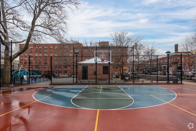 Carmansville Playground basketball court on a rainy day in Hamilton Heights.