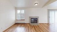 Located in Lakewood, WA, this single-floor residence offers three bedrooms, four bathrooms, and a thoughtfully arranged layout across a comfortable footprint. The living room serves as the heart of the home, featuring warm hardwood-style flooring, a classic brick corner fireplace, and a large window that fills the space with natural light. A hallway connects the living area to the rest of the home, maintaining a practical and efficient flow throughout.

The combined dining room and kitchen area is well-appointed with warm wood cabinetry, grey laminate countertops, a double stainless steel sink, and white appliances including an electric range and built-in microwave. A window above the kitchen provides additional natural light. The space opens directly toward the living room, creating a connected, social atmosphere.

The three bedrooms are generously proportioned, with the primary bedroom offering its own dedicated space. The secondary bedrooms feature plush carpet flooring and sliding wood-panel closet doors, offering practical storage. Five closets are distributed throughout the home for additional organization.

The four bathrooms are cleanly finished, featuring wood-framed mirrors, neutral countertops, and tub/shower enclosures with light-toned surrounds. An in-unit laundry area adds everyday convenience, rounding out a well-equipped and functional home.