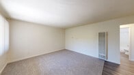 Located at 713 E Travis in Fairfield, California, this single-floor, two-bedroom, one-bathroom residence offers a practical and functional layout. The open-concept kitchen and living area serves as the heart of the home, featuring durable wood-style flooring, a wall-mounted A/C unit, and a large window with vertical blinds that allow ample natural light and views of the surrounding greenery. The kitchen is equipped with white cabinetry, a gas range, over-the-range microwave, and a refrigerator, complemented by stone-style countertops and a convenient breakfast bar peninsula.

Both bedrooms are carpeted and finished with neutral tones, creating a calm and comfortable atmosphere. The primary bedroom includes a double-door closet, providing generous storage space. Each bedroom features windows with vertical blinds, allowing natural light to filter in. A hallway connects the main living spaces, adding to the efficient flow of the floor plan.

The full bathroom is finished with white tile and includes a full-size bathtub with a shower. Throughout the residence, clean white walls and neutral finishes contribute to a bright, move-in-ready environment suited for everyday living.