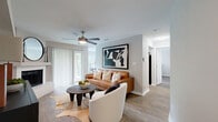 This one-bedroom, one-bathroom residence in Austin, TX offers a thoughtfully designed single-story layout that maximizes every inch of its space. The dual living areas feature wood-look flooring, neutral gray walls, and ceiling fans throughout, creating a bright and cohesive atmosphere. A standout white tile fireplace anchors one of the living areas, adding warmth and architectural character. Sliding glass doors in the main living area allow natural light to flow in and provide outdoor views. The galley-style kitchen is outfitted with white shaker cabinetry, a mosaic tile backsplash, stainless steel appliances, and ample counter space, opening toward the bathroom corridor for a connected feel. The dedicated dining area benefits from a window overlooking greenery, offering a calm and inviting setting. The bedroom is a comfortable retreat with wood-look flooring, a ceiling fan, a natural light-filled window, and a dedicated closet. The bathroom features white cabinetry, a large vanity mirror, and clean finishes. A separate laundry room with full-size washer and dryer adds everyday convenience. Architectural details such as curved wall transitions lend a distinctive touch to this well-appointed Austin residence.