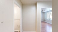 Located at 1330 Boren Ave in Seattle's First Hill neighborhood, this one-bedroom, one-bathroom unit offers a thoughtfully organized layout across a single floor. The main living area is generously proportioned for the bedroom, showcasing warm hardwood floors that run throughout and a ceiling fan overhead for year-round comfort. Large windows along multiple walls invite abundant natural light and offer pleasant views of surrounding greenery, creating a bright and airy atmosphere. The space transitions seamlessly into a compact kitchen area, distinguished by tile flooring, wood-toned cabinetry, and a full-size refrigerator. A dedicated hallway connects the main living space to the additional rooms, providing a clear sense of separation and privacy. The closet features built-in shelving, offering practical and organized storage. The bathroom is clean and functional, appointed with tile flooring, a pedestal sink, a medicine cabinet with mirror, and a baseboard heater, maintaining a classic and tidy aesthetic. Neutral wall tones throughout the unit contribute to a calm, versatile ambiance well-suited for a variety of interior styles. This unit combines efficient use of space with charming character details in a central Seattle location.