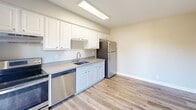 Located at 1118 Starbird Circle in San Jose, CA, this two-bedroom, one-bathroom unit offers a well-organized single-level layout with modern updates throughout. Light wood-style flooring flows consistently across all rooms, creating a clean and cohesive aesthetic.

The kitchen is efficiently designed with white cabinetry, grey countertops, a stainless steel refrigerator, dishwasher, and a skylight-style ceiling fixture that brightens the space. An adjacent open area provides flexibility for a dining arrangement.

Both bedrooms are comfortably sized, with the primary bedroom offering a ceiling fan with light fixture and a window that invites natural light and outdoor views. Mirrored sliding closet doors add a functional and space-enhancing touch.

The bathroom features a rich dark-wood vanity with ample drawer and cabinet storage, a grey countertop, an undermount sink, and a well-lit mirror with a classic multi-bulb fixture overhead.

A private balcony extends the living space outdoors, offering views of a sparkling community pool surrounded by mature palm trees and lush landscaping — a standout feature that brings a resort-like feel to everyday living. The stucco exterior and manicured grounds complete the setting.