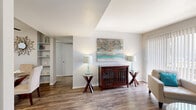 Located at 200 S Pantano Rd in Tucson, Arizona, this well-appointed one-bedroom, two-bathroom residence offers a thoughtfully designed single-floor layout. Wood-look plank flooring flows through the main living areas, lending a warm and cohesive feel throughout.

The living room is bright and inviting, featuring a large sliding glass door with vertical blinds that allow natural light to fill the space. It connects seamlessly to a dedicated dining area, which includes built-in wall shelving — a practical and attractive detail for display or storage.

The kitchen is efficiently laid out with crisp white cabinetry, granite-style countertops, black appliances including a range and dishwasher, and a stainless steel sink. A closet within the kitchen provides additional storage.

The bedroom offers comfortable carpeted flooring, a natural window with curtains, and an open shelving unit. It is conveniently positioned near a full bathroom featuring a white vanity with under-cabinet storage, a framed mirror, and a separate water closet. A second full bathroom includes a shower-tub combination, completing the two-bathroom layout.

Neutral wall tones, textured ceilings, and consistent finishes create a clean, move-in-ready ambiance throughout this compact yet functional Tucson residence.