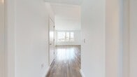 This 410 square foot studio apartment at 1300 Fairmount Ave offers a contemporary living space designed for urban efficiency. The open floor plan maximizes the use of space, seamlessly blending the living area with the kitchen. The living room is highlighted by large windows that flood the space with natural light and provide captivating city views, creating an airy and expansive feel despite the compact footprint.

The kitchen is a standout feature, boasting a modern design with a striking blue and white color scheme. It's equipped with stainless steel appliances, ample cabinet space, and a stylish backsplash, making it both functional and visually appealing. The warm wood flooring flows throughout the apartment, adding a touch of elegance and continuity to the space.

The bathroom is thoughtfully designed with contemporary fixtures, including a floating vanity and a combination tub-shower with sleek glass doors. Hexagonal tile accents add a touch of visual interest to the space. A closet provides essential storage, while the entrance area smoothly transitions into the main living space. Despite its modest size, this apartment offers a well-planned layout that maximizes functionality and style in every square foot.