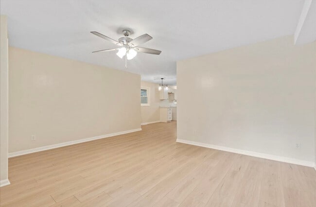 Large living room features LVP flooring and ceiling fan - 6362 E County Road 200 N