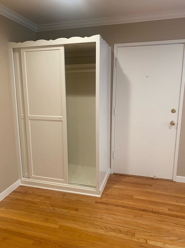 LIVING ROOM WITH BUILT IN WARDROBE CLOSET OPEN - 3017 W Riverside Dr