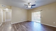 This single-story, 2-bedroom, 1-bathroom home in Round Rock, Texas offers a practical and comfortable layout across a well-utilized floor plan. The living room is a welcoming open space featuring wood-style plank flooring, a ceiling fan with light fixture, and a sliding glass door fitted with vertical blinds that fills the room with natural light and provides outdoor access. A dedicated entry door adds convenience and security to the space.

The galley-style kitchen is thoughtfully designed with gray cabinetry, dark countertops, and stainless steel appliances including a refrigerator, stove, and oven, all complemented by the same wood-style flooring that flows through the common areas.

Both bedrooms are carpeted for comfort and include ceiling fans. Each room features window blinds that allow for adjustable natural light. The primary bedroom offers a generous footprint with ample wall space, while the second bedroom provides a comfortable and functional layout.

The bathroom features a full tub and shower combo with a clean white surround, chrome fixtures, and wood-style flooring. A closet and hallway round out the layout, providing practical storage and smooth flow throughout the home. Neutral warm-toned walls throughout create a cohesive and inviting atmosphere.