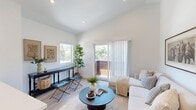 Located at 564 Higuera St in San Luis Obispo, CA, this thoughtfully designed two-story home offers 1 bedroom and 2 full bathrooms across two well-proportioned floors. The main level features an open-concept kitchen and living area bathed in natural light from soaring vaulted ceilings. The kitchen is equipped with stainless steel appliances, white shaker cabinets, a subway tile backsplash, quartz countertops, and pendant lighting over the peninsula island. Light wood-look flooring flows throughout, enhancing the bright, airy atmosphere. The living room opens directly to a private balcony through sliding glass doors, framing stunning hillside views of San Luis Obispo's rolling terrain. A wall-mounted mini-split unit provides efficient climate control. The upper-level primary bedroom features plush carpet, multiple windows offering abundant natural light and outdoor views, a ceiling fan, and a dedicated mini-split system. Two closets provide generous storage. Both bathrooms are finished in crisp white with wood-look tile flooring — one includes a full soaking tub with shower, while the other features a vanity with an illuminated LED mirror. The overall design aesthetic is clean, modern, and cohesive throughout.