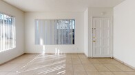Located at 20557 Osage Ave in Torrance, California, this single-floor residence offers a clean, functional layout across several well-defined living spaces. The bright living area features light-toned ceramic tile flooring, white walls, and a textured ceiling, with large windows dressed in vertical blinds that invite natural light throughout the day. A front entry door with sidelights enhances the welcoming atmosphere of the main living space.

The kitchen is equipped with white cabinetry, a granite-toned countertop, a built-in microwave, electric range, dishwasher, and a sink positioned beneath a window — all finished with matching light tile flooring and a ceiling fan for added comfort.

The bedrooms are carpeted and offer a cozy, quiet feel. One bedroom features a mirrored sliding closet door, while another offers a wide window with views of palm trees and the surrounding Torrance neighborhood, providing a pleasant outdoor connection. Both rooms feature textured ceilings and ceiling fans.

Two full bathrooms serve the residence — one with a walk-in shower and a vanity with a granite-style countertop, and another with a full tub-shower combination, toilet, and matching vanity. Both bathrooms are finished with light ceramic tile flooring, maintaining a consistent and cohesive aesthetic throughout the home.