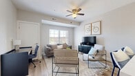 Located at 5711 Menerey Ln in Columbus, OH, this well-appointed one-bedroom, one-bathroom unit offers a thoughtfully designed single-floor layout with a clean, contemporary aesthetic. Light wood-tone flooring flows throughout the space, complementing a neutral color palette that creates a bright and cohesive feel.

The open-concept kitchen and living area serves as the heart of the unit. The kitchen features dark espresso cabinetry contrasted by crisp white upper cabinets and quartz countertops, a subway tile backsplash, stainless steel appliances including a full-size refrigerator, range, and microwave, and a peninsula with bar seating illuminated by modern pendant lighting. The adjoining living area receives natural light through a large window and is outfitted with a ceiling fan for added comfort.

The bedroom is a comfortable retreat with room for a full sleeping and workspace setup, and includes access to a dedicated walk-in closet. The bathroom offers a glass-enclosed shower, wood-look flooring, and clean white finishes. Additional spaces include a laundry area, multiple closets, and utility rooms, providing excellent storage and functionality. The overall ambiance is modern, clean, and move-in ready.