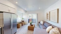 Located on Higuera Street in the heart of San Luis Obispo, CA, this thoughtfully designed one-bedroom, one-bathroom unit makes excellent use of its compact footprint. The open-concept kitchen and living area serves as the core of the home, bathed in natural light from a large sliding glass door that opens to a private balcony with outdoor views. The living area features light wood-style flooring, recessed lighting, and a mini-split HVAC unit, creating a comfortable and modern atmosphere throughout.

The kitchen is well-appointed with white shaker cabinetry, quartz countertops, a glossy subway tile backsplash, and a full suite of stainless steel appliances including a refrigerator, range, microwave, and dishwasher. Clean lines and ample storage make this kitchen both functional and visually appealing.

The bedroom is a quiet, cozy retreat with a window that brings in natural light and a dedicated closet for storage. The bathroom features warm wood-look flooring, a white vanity with an undermount sink, gold-accented hardware, and a sleek LED-backlit mirror, all accented by a bright window that enhances the clean, spa-like aesthetic. The unit's consistent use of neutral tones, modern fixtures, and natural light creates a cohesive and inviting living environment.