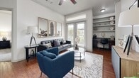 Located at 15330 Liberty River Dr in Houston, TX, this single-story residence offers a thoughtfully designed layout with a cohesive, neutral aesthetic throughout. The living room serves as the heart of the home, showcasing rich hardwood floors, crown molding, elevated ceilings with a ceiling fan, and French doors that invite natural light and provide outdoor access. Built-in shelving and a dedicated desk area make the space as functional as it is inviting. Adjacent to the living room, the dining nook offers an intimate setting highlighted by warm hardwood flooring and accent lighting. The galley-style kitchen is well-equipped with dark cabinetry, granite-style countertops, and black stainless appliances, including a refrigerator and range, with a convenient louvered door leading to a dedicated laundry area with a full-size washer. The bedroom is a serene retreat featuring plush carpeting, generous natural light from a large window with outdoor views, and direct access to a spacious walk-in closet. The full bathroom includes tile flooring, a tub-shower combination with white tile surround, a dark wood vanity, and granite countertops. Throughout the home, a clean, modern design sensibility ties each room together seamlessly.