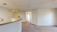 Located at 50 Meadows Drive in Lebanon, Tennessee, this single-floor home offers three bedrooms, two bathrooms, a kitchen, and two closets within a well-organized layout. The living area is carpeted and features a ceiling fan along with French doors that invite natural light and provide outdoor access, creating a bright and open atmosphere. The galley-style kitchen is efficiently designed with warm wood-toned cabinetry, white appliances including a range and refrigerator, a single-basin sink, and tile flooring. A skylight overhead adds additional natural illumination to the cooking space. A curved breakfast bar connects the kitchen to the adjacent living area, enhancing the open flow of the home. The bedrooms are carpeted and finished with neutral walls; the primary bedroom benefits from two windows and a ceiling fan, while the additional bedrooms are well-proportioned and filled with natural light. Both bathrooms are clean and functional — one features tile flooring with a vanity and full bathtub, while the other offers a similar tub-shower layout with crisp white finishes. A central hallway connects the bedrooms and bathrooms, providing a practical and organized floor plan throughout.