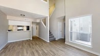 Located at 2130 Breckenridge Dr in Arlington, TX, this two-story, 3-bedroom, 3-bathroom home offers a well-designed layout spread across two floors. The main level features a bright, open living room with soaring ceilings that flood the space with natural light through tall windows. A classic fireplace with a dark surround serves as a focal point, complemented by wood-look plank flooring that extends throughout the lower level. The kitchen is positioned adjacent to the living area with a pass-through bar counter, subway tile backsplash, white cabinetry, and built-in appliances, making it both functional and stylish. A carpeted staircase connects the two floors. Upstairs, the generously sized primary bedroom provides a comfortable retreat, accompanied by a walk-in closet with built-in shelving and railing. The bathrooms are finished with clean white cabinetry, light countertops, and wood-look tile flooring. Two additional bedrooms feature plush carpeting, textured ceilings, and neutral tones. A connecting hallway ties the upper floor together seamlessly. Throughout the home, a neutral color palette and consistent finishes create a cohesive and welcoming ambiance.