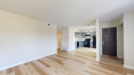 Located at 4653 Refugee Road in Columbus, Ohio, this two-bedroom, one-bathroom single-floor home offers a clean, updated interior with a bright and cohesive design throughout. Light-toned hardwood flooring flows seamlessly through the main living areas, creating a warm and inviting ambiance.

The open-concept living room and kitchen area serves as the heart of the home. The kitchen is well-appointed with gray shaker-style cabinetry, light marble-look countertops, a stainless steel sink, and a full suite of black appliances including a range, refrigerator, and dishwasher. A pendant light adds a stylish focal point above the kitchen space.

The primary bedroom is a standout feature, showcasing a distinctive shiplap accent wall that adds texture and character, complemented by light hardwood flooring and a window that brings in natural light with views of greenery outside. The second bedroom is carpeted and equally bright, with neutral walls and a window overlooking the outdoors.

The bathroom is clean and functional, featuring a tub-shower combo, a white vanity with countertop, and a mirrored medicine cabinet. The home also includes an impressive five closets for abundant storage, a utility room, and a hallway connecting the main spaces. The overall aesthetic is fresh, modern, and move-in ready.