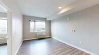 Located at 508 51st Street in West New York, NJ, this one-bedroom, one-bathroom unit offers a well-designed layout across a single floor. The living area features light hardwood-style flooring and neutral warm-toned walls, creating a clean and inviting atmosphere. Large windows allow abundant natural light to fill the space while framing elevated panoramic views of the surrounding cityscape and beyond — a standout feature visible from both the living area and bedroom.

The kitchen is outfitted with modern flat-front wood-toned cabinetry extending to the ceiling for generous storage, white quartz countertops, a light tile backsplash, and a full suite of stainless steel appliances including a refrigerator, electric range, and built-in microwave.

The bedroom is a comfortable, well-proportioned room with the same hardwood-style flooring, a large picture window with expansive views, a wall-mounted HVAC unit, and a double-door closet providing ample storage.

The bathroom maintains the unit's modern aesthetic with a wood-toned vanity, white quartz countertop, a framed mirror, and tile flooring. A separate shower is also present. Throughout the unit, clean lines, consistent finishes, and thoughtful details contribute to a cohesive and contemporary living environment.