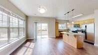 Located at 515 Aurora in Bend, Oregon, this two-story, 4-bedroom, 2-bathroom home offers a well-designed layout spread across two floors. The main level opens into a bright, open-concept living and kitchen area bathed in natural light from large windows and a sliding glass door that leads to an outdoor balcony. The kitchen is well-appointed with light maple cabinetry, granite countertops, stainless steel appliances, a center island with pendant lighting, and a gas range — ideal for both everyday cooking and entertaining. The living area features rich hardwood-style flooring and a stone-surround fireplace, adding warmth and character to the space. Upstairs, four carpeted bedrooms provide comfortable retreats, each with ample natural light. The primary bedroom includes a dedicated closet with built-in shelving. Both bathrooms are finished with tile flooring, wood-toned vanities, and clean, neutral tones. A dedicated laundry room with full-size washer and dryer hookups adds everyday convenience. Throughout the home, neutral walls, consistent flooring, and well-proportioned rooms create a cohesive and inviting atmosphere well-suited to a variety of lifestyles.