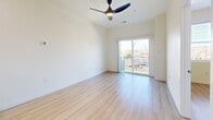Located at 2211 Rio Grande Blvd NW in Albuquerque, New Mexico, this thoughtfully designed one-bedroom, one-bathroom unit offers a clean, contemporary aesthetic throughout its efficiently planned single-floor layout. Light-toned luxury vinyl plank flooring runs seamlessly through every room, complementing the bright, neutral wall palette and creating a cohesive, modern feel.

The open-concept living, dining, and kitchen area forms the heart of the unit. The kitchen is well-appointed with crisp white shaker cabinetry, granite countertops, a stainless steel sink, and a full suite of stainless steel appliances including a refrigerator, range, over-the-range microwave, and dishwasher. A peninsula with bar seating provides additional prep space and a natural division between the kitchen and living area. A ceiling fan overhead and a sliding glass door leading to a private balcony allow for natural light and outdoor views of the surrounding neighborhood.

The bedroom is a comfortable, well-lit retreat featuring a ceiling fan, a large window with neighborhood views, and direct access to a dedicated closet. The bathroom is finished with white cabinetry, a marble-style tiled tub and shower surround, and matching flooring. Additional conveniences include an in-unit laundry area and an electrical panel, rounding out this efficiently designed and move-in-ready residence.