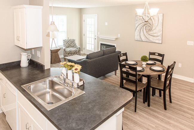 Typical Apartment Great Room with Faux Wood Flooring & FIreplace - Green Wood Park Townhouses & Apartments