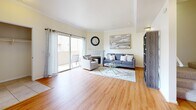 Located at 17621 W Pauline Ct in Santa Clarita, CA, this three-story home offers a well-organized layout across three distinct levels, blending functional living spaces with comfortable design. The main living level features warm hardwood flooring throughout a spacious living room, complete with crown molding, a fireplace, and sliding glass doors that open to a private balcony, filling the space with natural light. Adjacent to the living room, the dining area accommodates an intimate dining set beneath a bright window with neighborhood views. The kitchen is outfitted with honey-toned wood cabinetry, dark granite countertops, stainless steel appliances, tile flooring, and a convenient breakfast bar. Three full bathrooms serve the home, each featuring tub-shower combinations with glass enclosures and clean tile finishes. The primary bedroom is carpeted and generously proportioned, with access to a dedicated closet and elevated ceilings that add to the sense of space. A versatile office with mirrored closet doors, plush carpet, a ceiling fan, and ample natural light provides an ideal work-from-home environment. A dedicated laundry room with full-size washer and dryer hookups adds everyday convenience. Crown molding and neutral tones are carried throughout, creating a cohesive and polished ambiance.